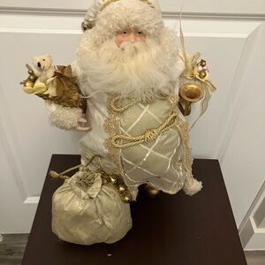 white and gold Santa Claus figurine